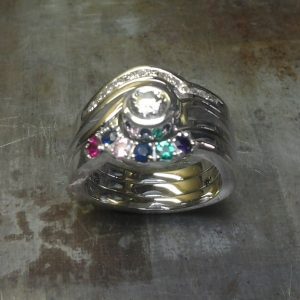 custom family ring with multiple birthsones and diamonds