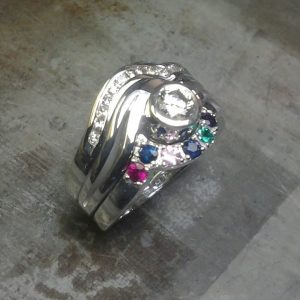 custom family ring with multiple birthsones and diamonds side view
