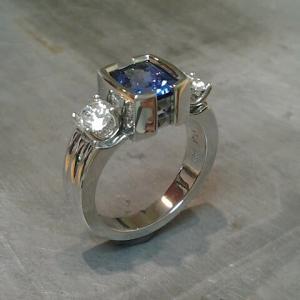 white gold with diamonds and large sapphire in square setting