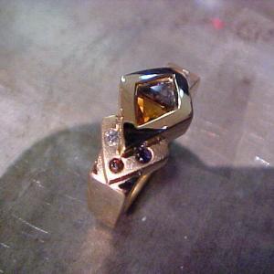 custom gold ring with multiple colored gems