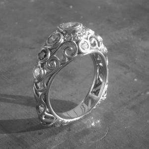 Open style Art deco inspired scroll engagement ring.