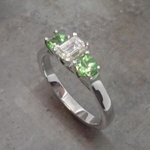 Emerald cut diamond and Tsavorite engagement ring