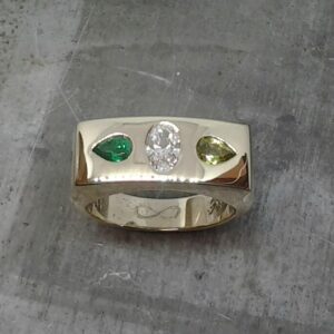 Pear shape emerald oval diamond gypsy set engagement ring